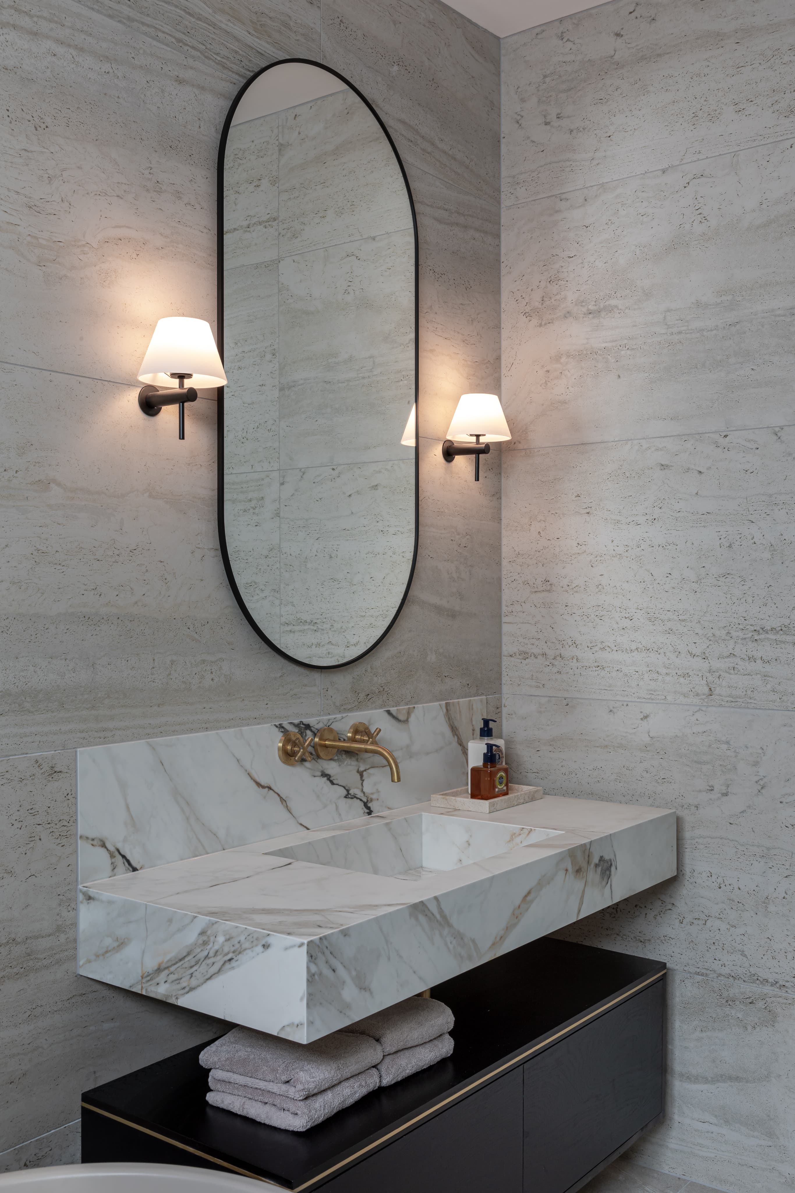Matte black fixtures with marble vanity