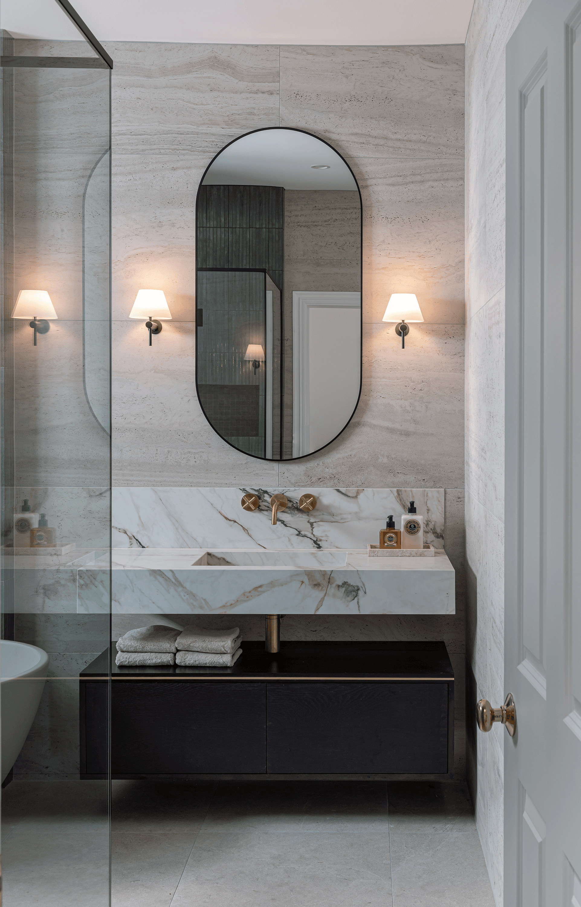 Modern bathroom with marble vanity and brass fixtures