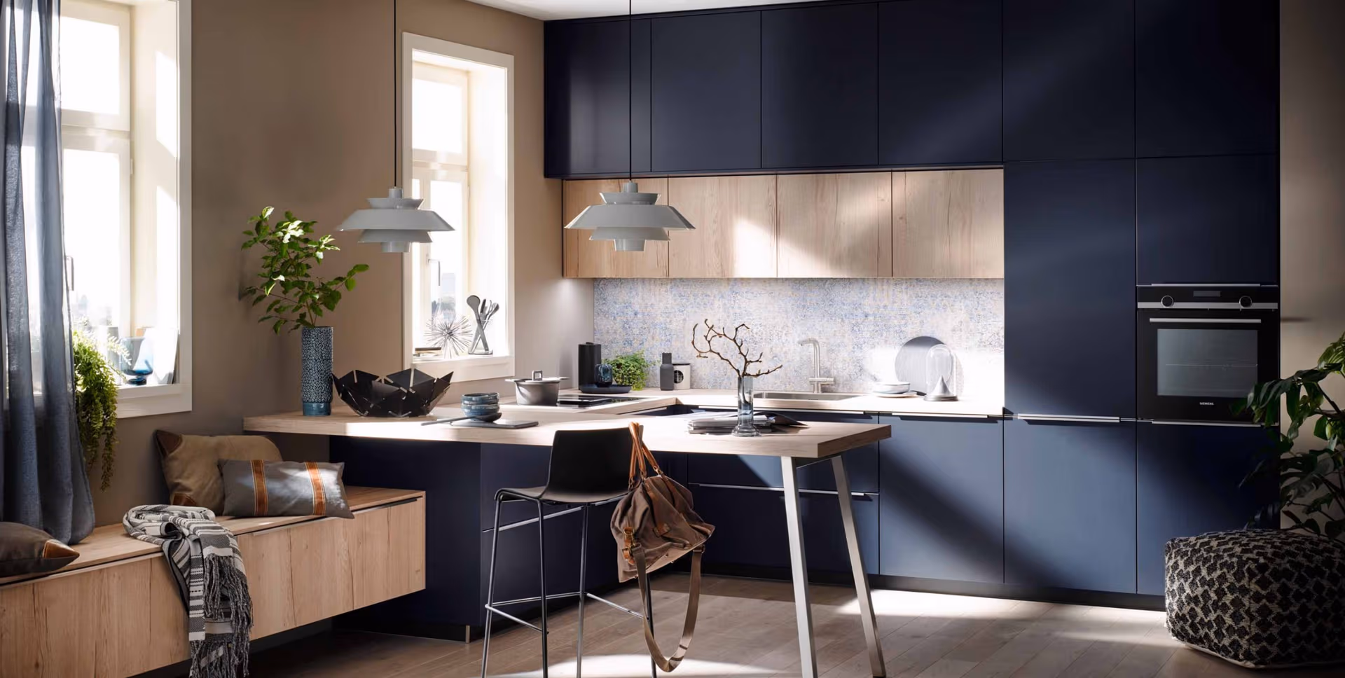 A contemporary kitchen that seamlessly blends cooking, dining, and living areas through clean lines, a soft neutral palette, and natural light.