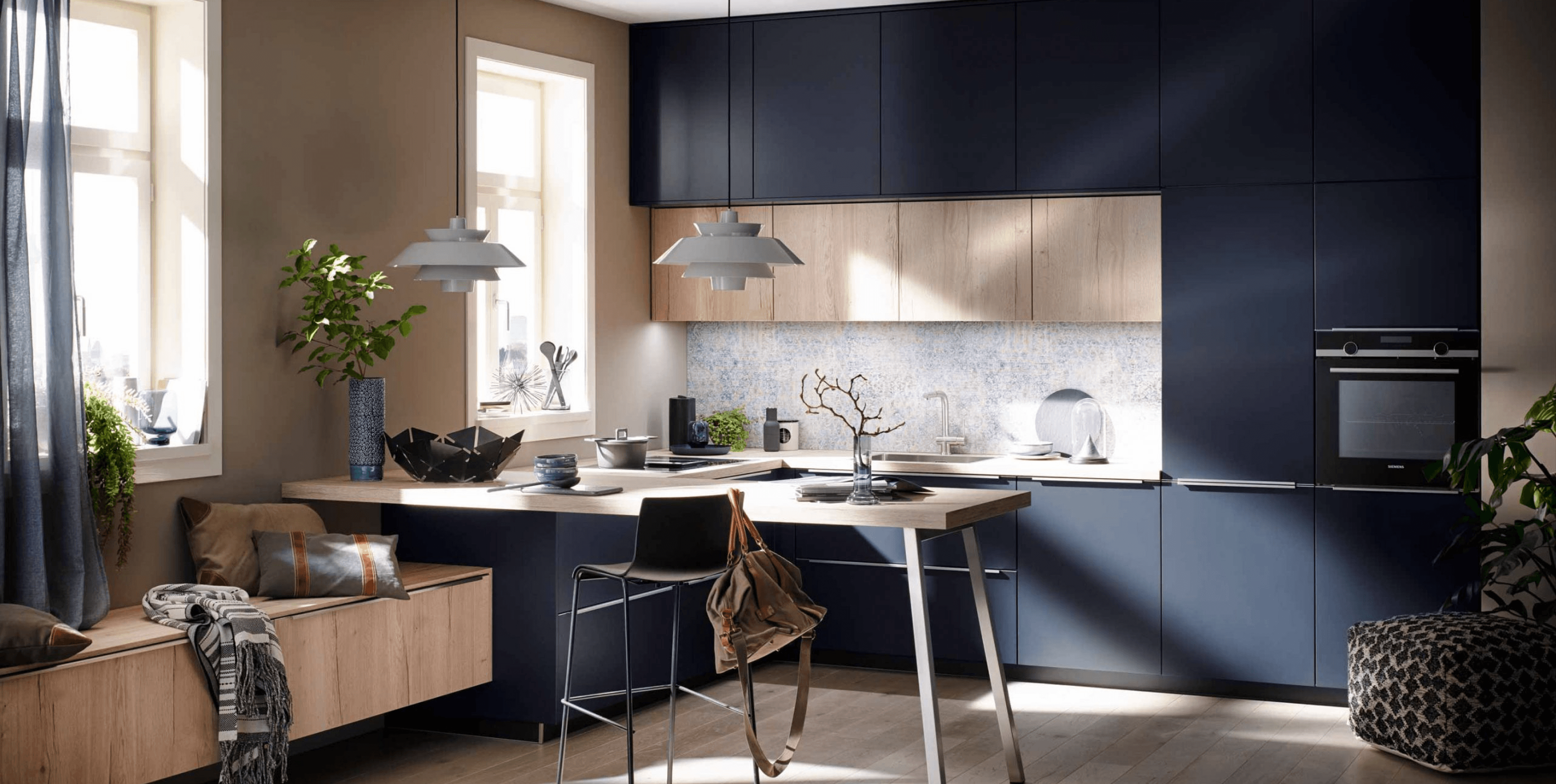 A contemporary kitchen that seamlessly blends cooking, dining, and living areas through clean lines, a soft neutral palette, and natural light.