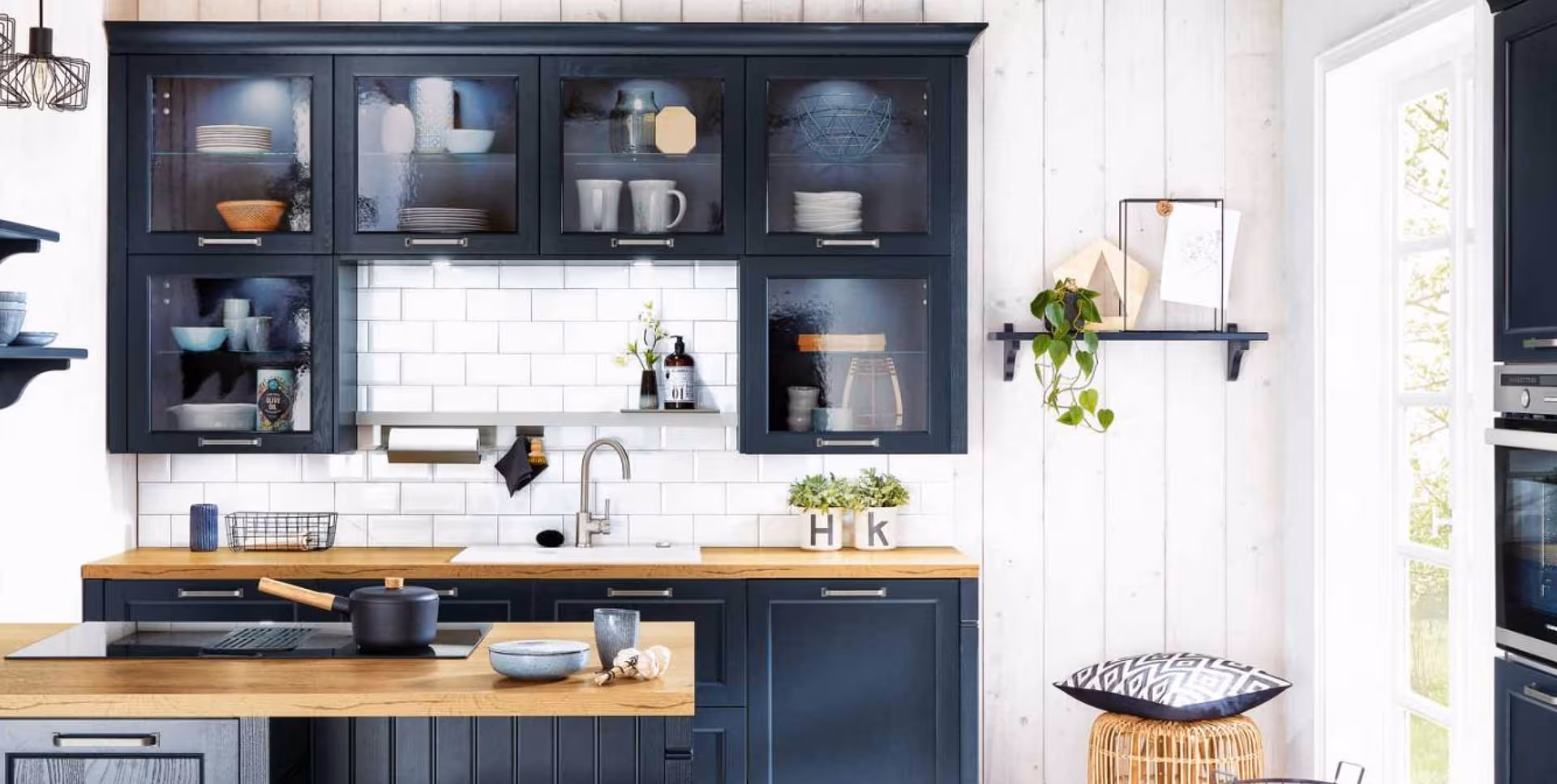 Deep blue cabinetry, glass displays and wood accents give this kitchen a relaxed yet refined character.