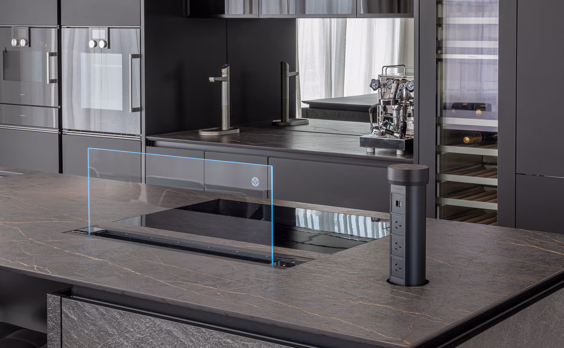 Integrated appliances, concealed features and advanced worktop technology create a space that feels both effortless and intelligently designed.