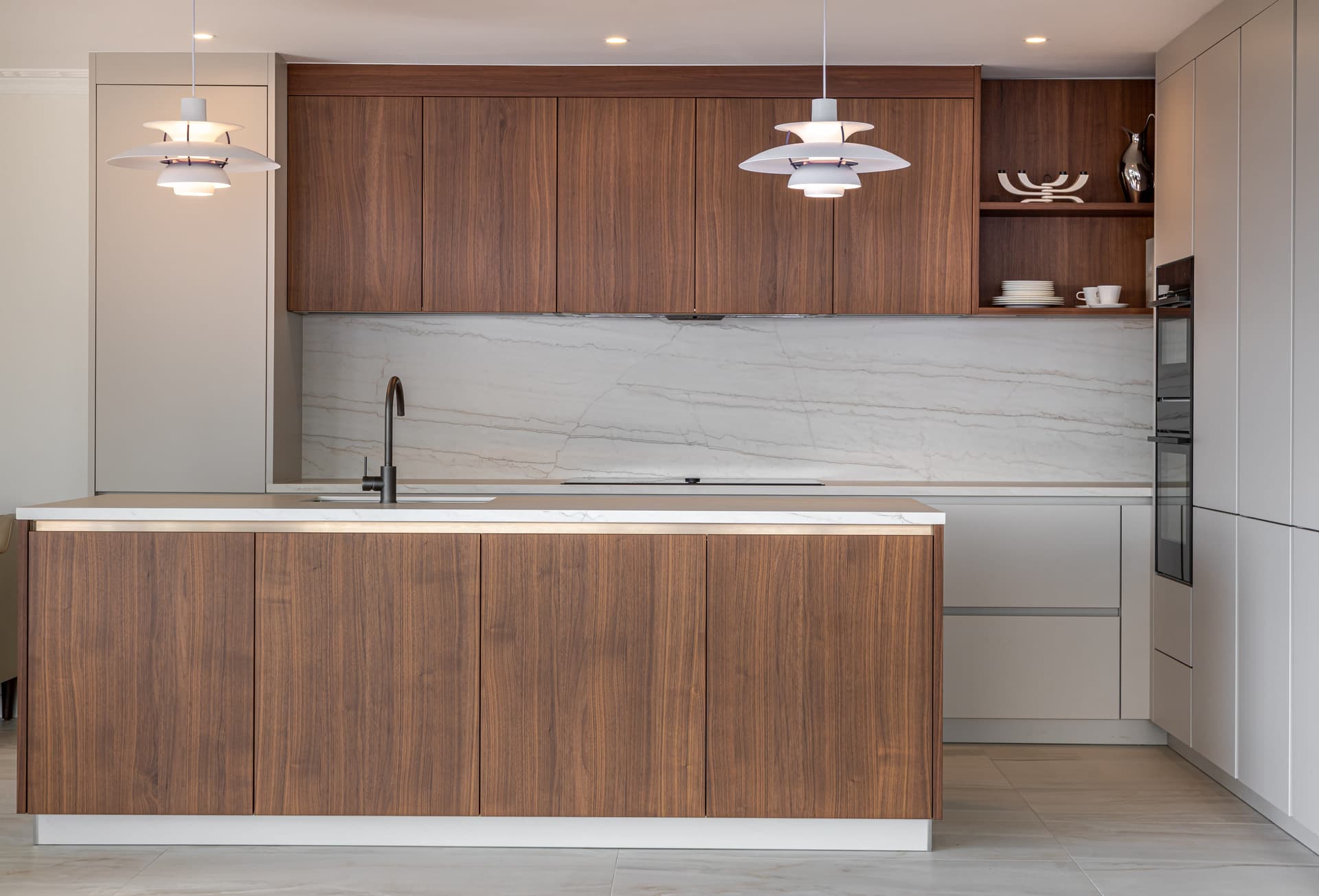 Kitchen with dark timber cabinetry, stone benchtop and a long island