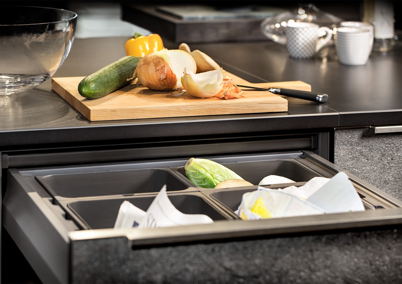 Pull-out waste drawer with separated bins for rubbish and recycling