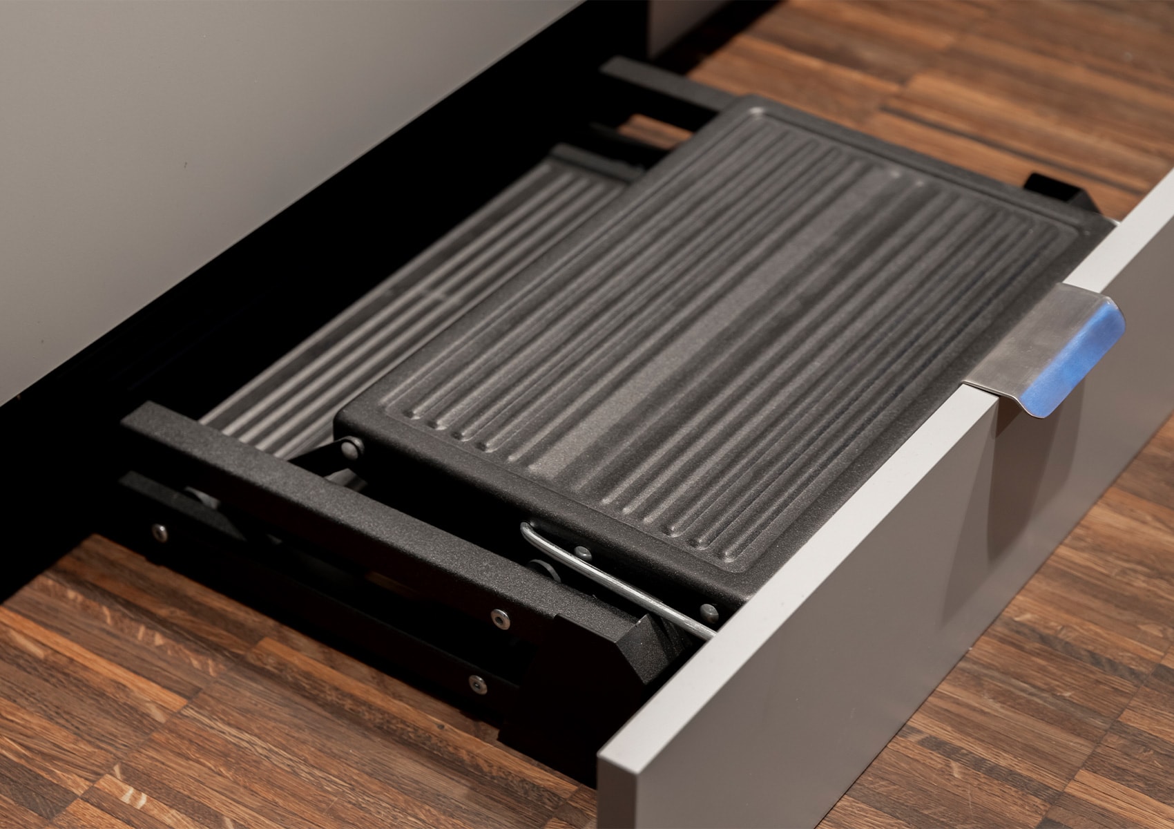 Step stool sliding out from the plinth beneath the cabinets