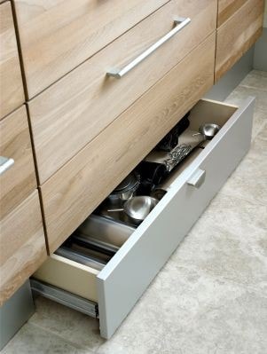 Toe-kick drawer open in the area beneath the cabinets