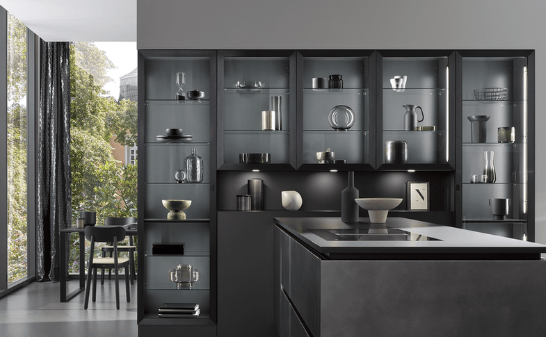 Wall of glass-fronted display cabinets with lit interiors