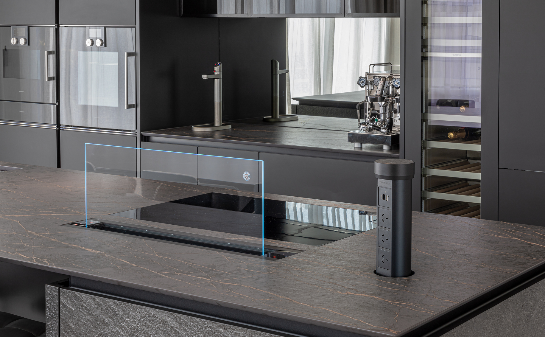 Integrated appliances, concealed features and advanced worktop technology create a space that feels both effortless and intelligently designed.