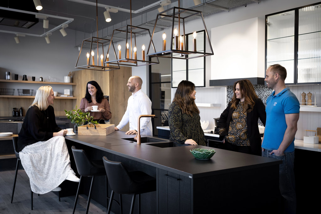 Häcker Kitchen designers catching up with clients after a succesful job
