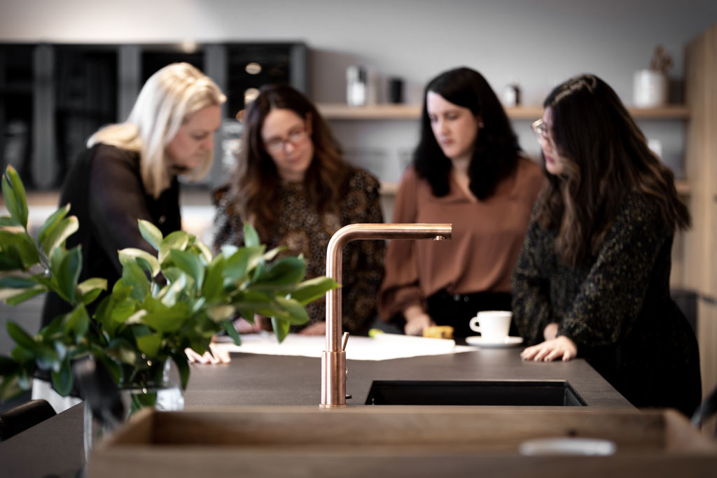 Our  Kitchen designers looking over our clients kitchen design before sending them coming into our showroom to view it